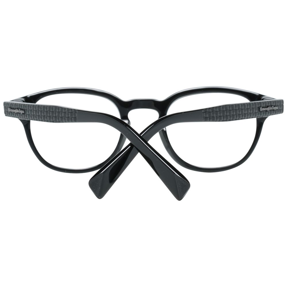 Ermenegildo Zegna Black Plastic Glasses shown from the back with crossed arms feature a glossy black rectangular frame and textured temple pattern, offering men's eyewear a sleek, modern look.