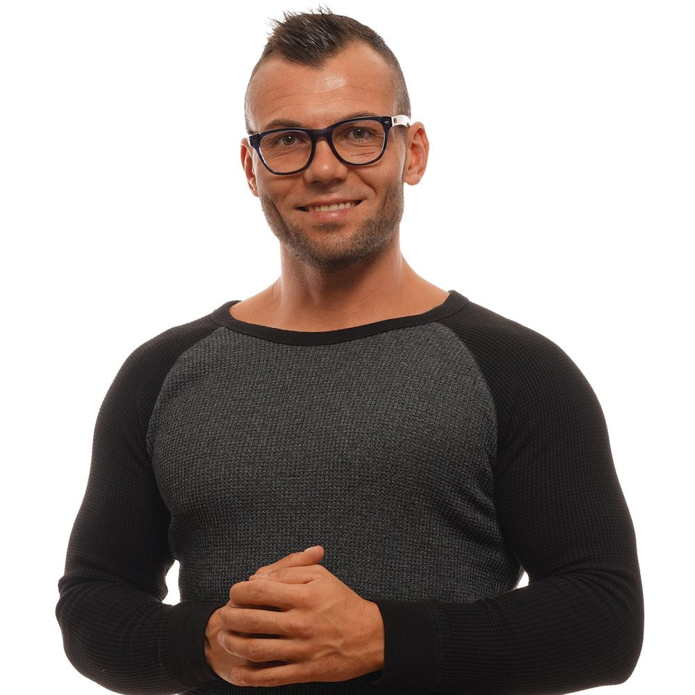 A man with short dark hair, smiling at the camera, wears Ermenegildo Zegna Blue Plastic Glasses and a black and gray long-sleeve shirt. He stands against a plain white background with his hands clasped in front.