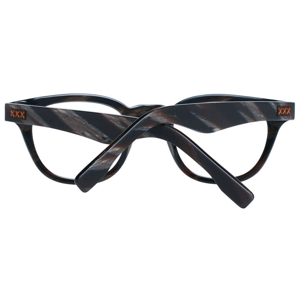A pair of Ermenegildo Zegna black plastic full-rim eyeglasses with crossed arms, displaying "Zegna" in orange on the temples.