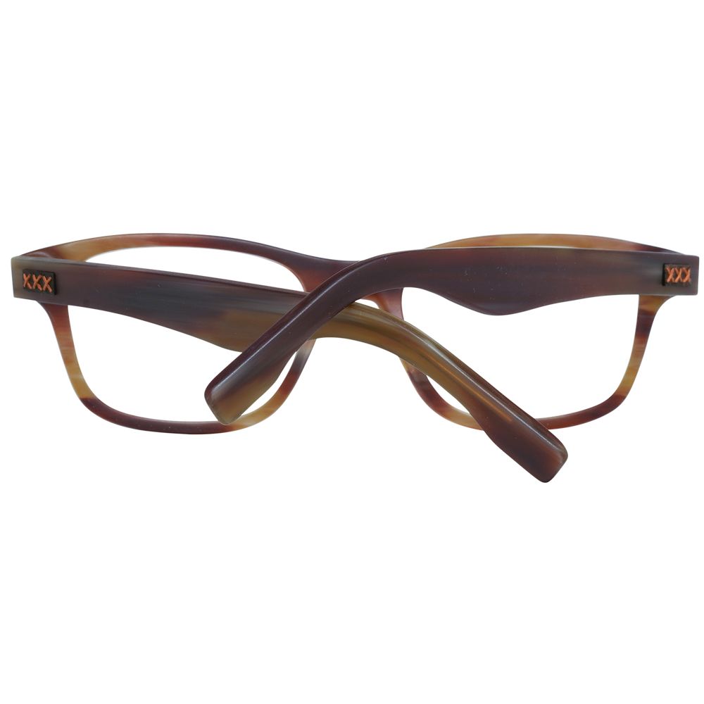 A pair of Ermenegildo Zegna brown plastic glasses (frames) for men is shown from the back with crossed arms, featuring small markings on the hinges.