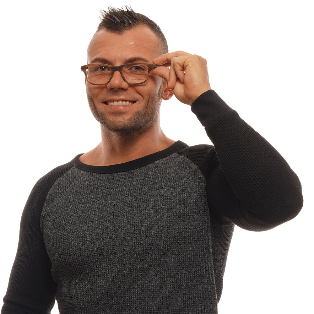 A smiling man wears Ermenegildo Zegna Brown Plastic Glasses (Frames) and a long-sleeved gray and black shirt, holding his glasses with one hand against a white background.